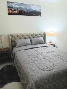a bedroom with a large bed with two night stands at แอนนา เรสซิเดนซ์ in Ban Dung