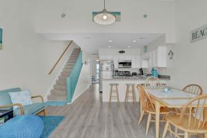 a kitchen and living room with a table and chairs at Amazing Sound View Home with Pool in North Topsail Beach +49 photos