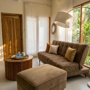 a living room with a couch and a table at CASA Habibi in Kuta Lombok