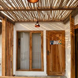 a house being constructed with a wooden door at CASA Habibi in Kuta Lombok