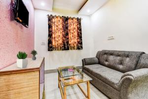 a living room with a couch and a table at Hotel O Lord Shiva in Bankipur