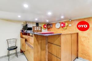 a kitchen with a counter and a chair in a room at Hotel O Lord Shiva in Bankipur +17 photos