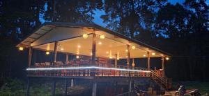 a house with a deck with chairs and lights at Konglor cave Resort - River side Restaurant in Ban Konglo