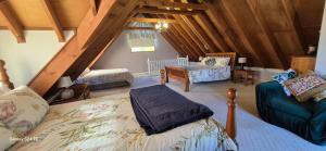 a bedroom with a bed and a chair in a attic at Firefly Resort in Firefly +41 photos