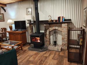 a fireplace in a living room with a stove at Firefly Resort in Firefly