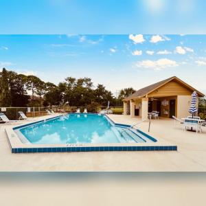 a swimming pool in front of a house at 2 Cute 2 Pass UP in Orlando