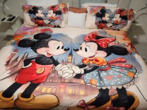 a bedroom with a mickey mouse bedspread with a cartoon at 2 Cute 2 Pass UP in Orlando +27 photos