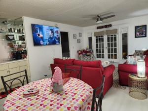 a living room with a red couch and a table at 2 Cute 2 Pass UP in Orlando