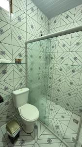 a bathroom with a toilet and a shower at Chalé Marinas in Barreirinhas