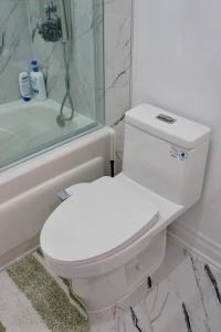 a bathroom with a white toilet and a shower at Comfortable Private Room in Toronto +11 photos