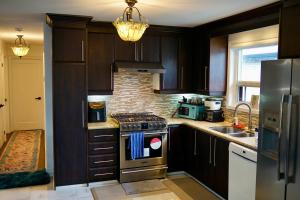 a kitchen with a stove and a sink at Comfortable Private Room in Toronto