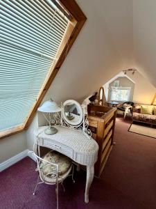 a attic room with a dressing table and a mirror at Ocean Breeze Executive Bed and Breakfast in North Vancouver