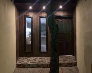 a room with a tree in front of a door at Arubaapartamentos in Oranjestad
