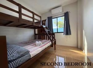 a bedroom with a bunk bed and a window at Blue Horizon in Bantayan Island