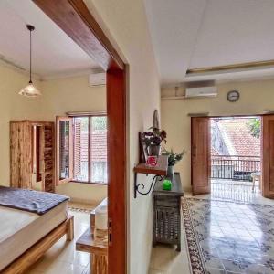 a bedroom with a bed and a view of a balcony at Sabi House Lesmana in Timuran +71 photos