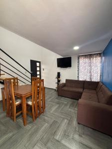 a living room with a couch and a table at Tiny House Molino Alto in Ciudad Fernández