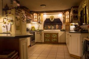 a large kitchen with white cabinets and a sink at Mi casa, tu casa in Guatemala