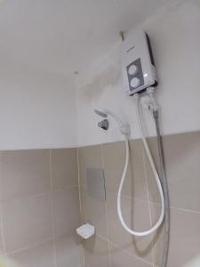 a shower in a bathroom with a shower head at Sol house in Pajak +14 photos