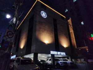 a building with cars parked in front of it at night at 브라운도트 영도 대교점 in Jung-gu