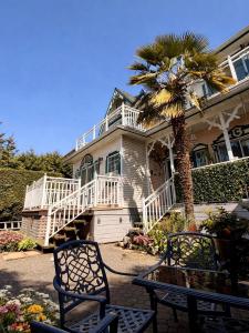 a house with a palm tree in front of it at Ocean Breeze Executive Bed and Breakfast in North Vancouver