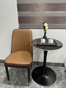 a table and a chair next to a table with a table at Khách Sạn MoonKnight 2 in Sầm Sơn