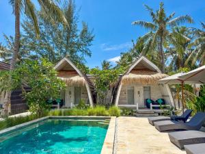 a villa with a swimming pool and palm trees at Gili Air Escape - Adults Only in Gili Islands