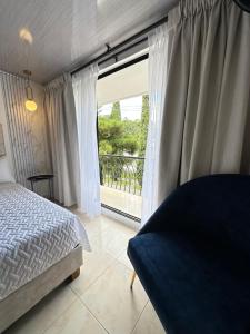 a bedroom with a bed and a large window at Hotel Alamos del Bosque in Pereira +88 photos