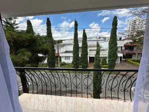 a balcony with a view of a bunch of trees at Hotel Alamos del Bosque in Pereira