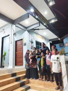 a group of people standing in front of a building at Perhentian Najmi Hotel in Perhentian Islands