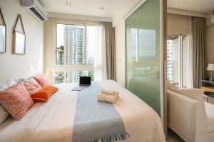 a large bed in a room with a large window at KingBed Beachfront-Pool Condo & Kitchen,Playground,TV,Wifi in Jomtien Beach +78 photos