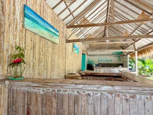 a room with a wooden wall with a counter at Gili Air Escape - Adults Only in Gili Islands