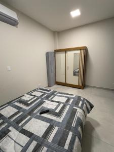 a bedroom with a bed and a mirror at New House, Long Stay in Maringá