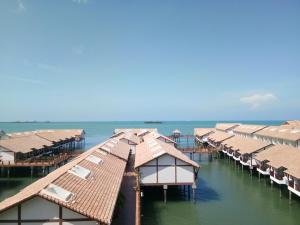 a row of houses on the water in the ocean at PD Full Seaview Water Chalet with Private Bathtub in Port Dickson
