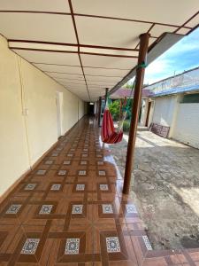 an empty hallway with awning and a hammock at Hostal Casa Colonial in Santa Ana +14 photos