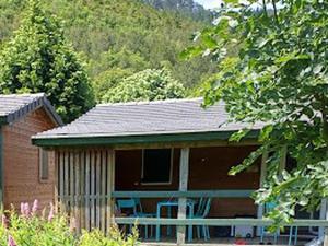 a house with blue chairs in front of it at Chalet accueillant - 4 pers. - API-1-52-2453 in Meyrueis
