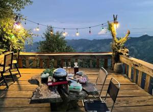 a patio with a table and chairs on a deck at Sơn Tra Our House in Bản Bé