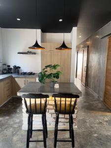a kitchen with a table and two chairs at El marqués casa boutique in Ríohacha +8 photos