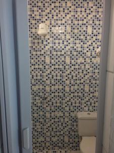 ein Bad mit einem WC und einer gefliesten Dusche in der Unterkunft Kitchenette Charmosa no Itagua in Ubatuba + 41 Fotos