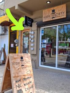 a sign in front of a high society store at Ánimo Perro in Sayulita