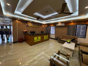 a lobby with a reception desk in a building at Hotel Seven View in Bāiljuri