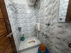 a bathroom with a toilet and a sink at Hotel Seven View in Bāiljuri