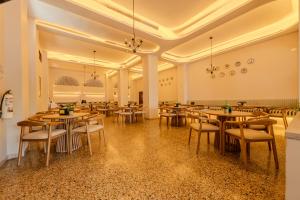 a large room with tables and chairs in it at Hotel Dorado Plaza Centro Histórico in Cartagena de Indias