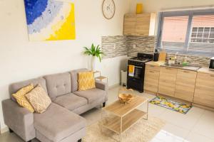 a living room with a couch and a kitchen at Maysi apartments in Willemstad