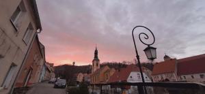 a city street with a church and a street light at Apartament Wiaduktowy in Srebrna Góra