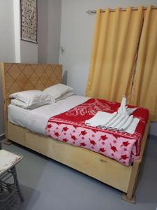 a bedroom with a bed with white towels on it at Bob marley luxor in Luxor