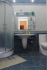 a bathroom with a sink and a toilet and a mirror at Baku Butik Mini-Hotel in Baku