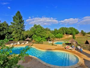 an image of a swimming pool at a resort at Cabane cosy pour 2 avec jacuzzi - API-1-52-2485 in Saint-Amand-de-Coly