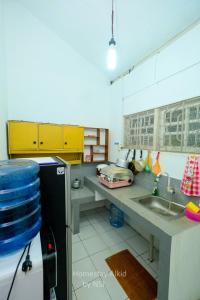 a kitchen with a sink and a counter top at Homestay Alkid in Timuran +6 photos