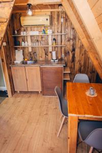 a kitchen with a table and chairs in a cabin at Mountain View in Tjentište +53 photos