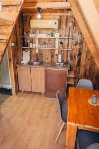 a kitchen with a table and chairs in a cabin at Mountain View in Tjentište